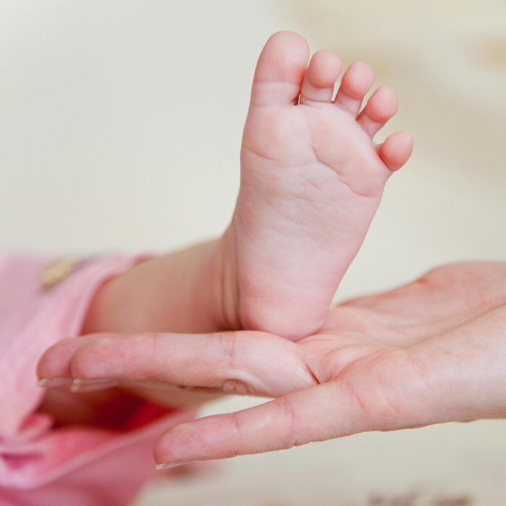Tender moment captured between a parent and their newborn in this intimate close-up.